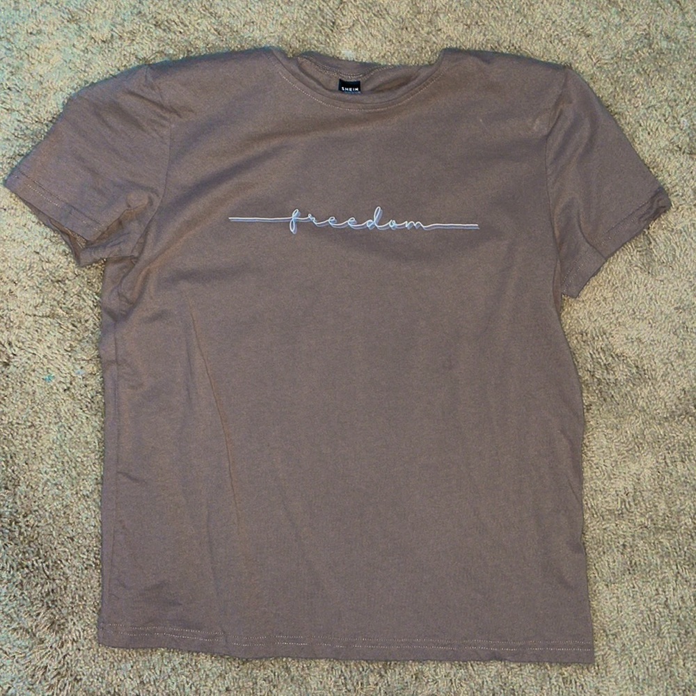 Light brown “freedom” t-shirt. Size small.